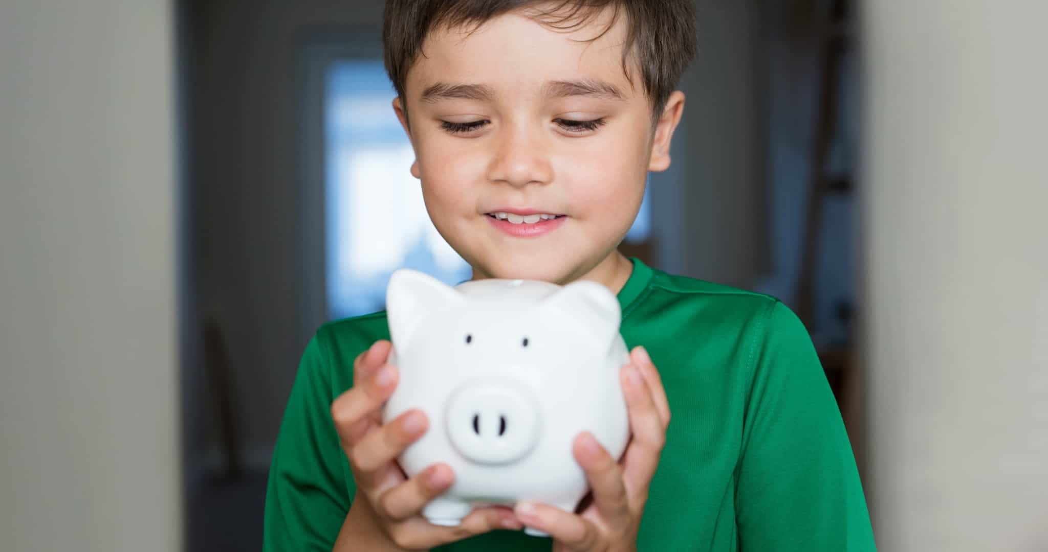 Child with piggy bank in hands learning financial decisions