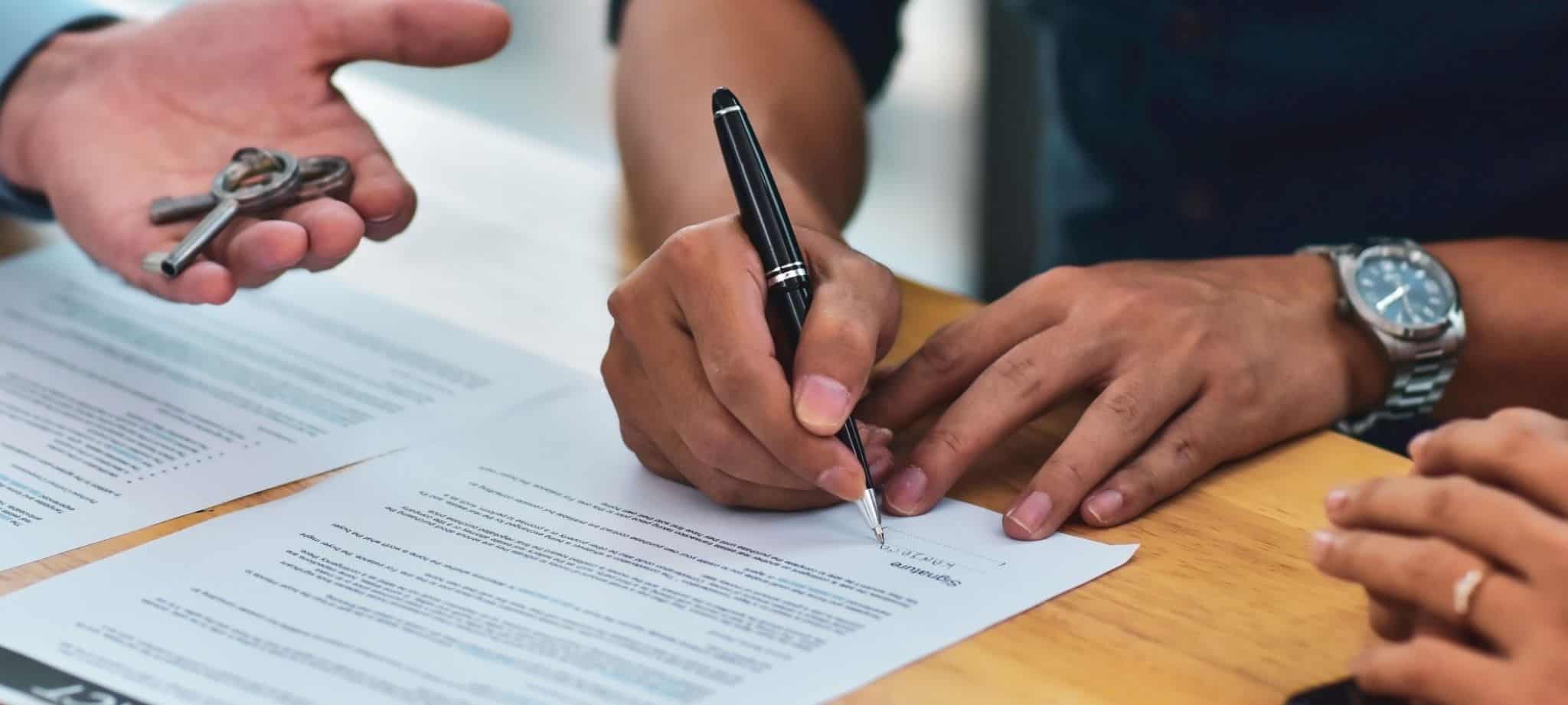 Man signing house purchase contract