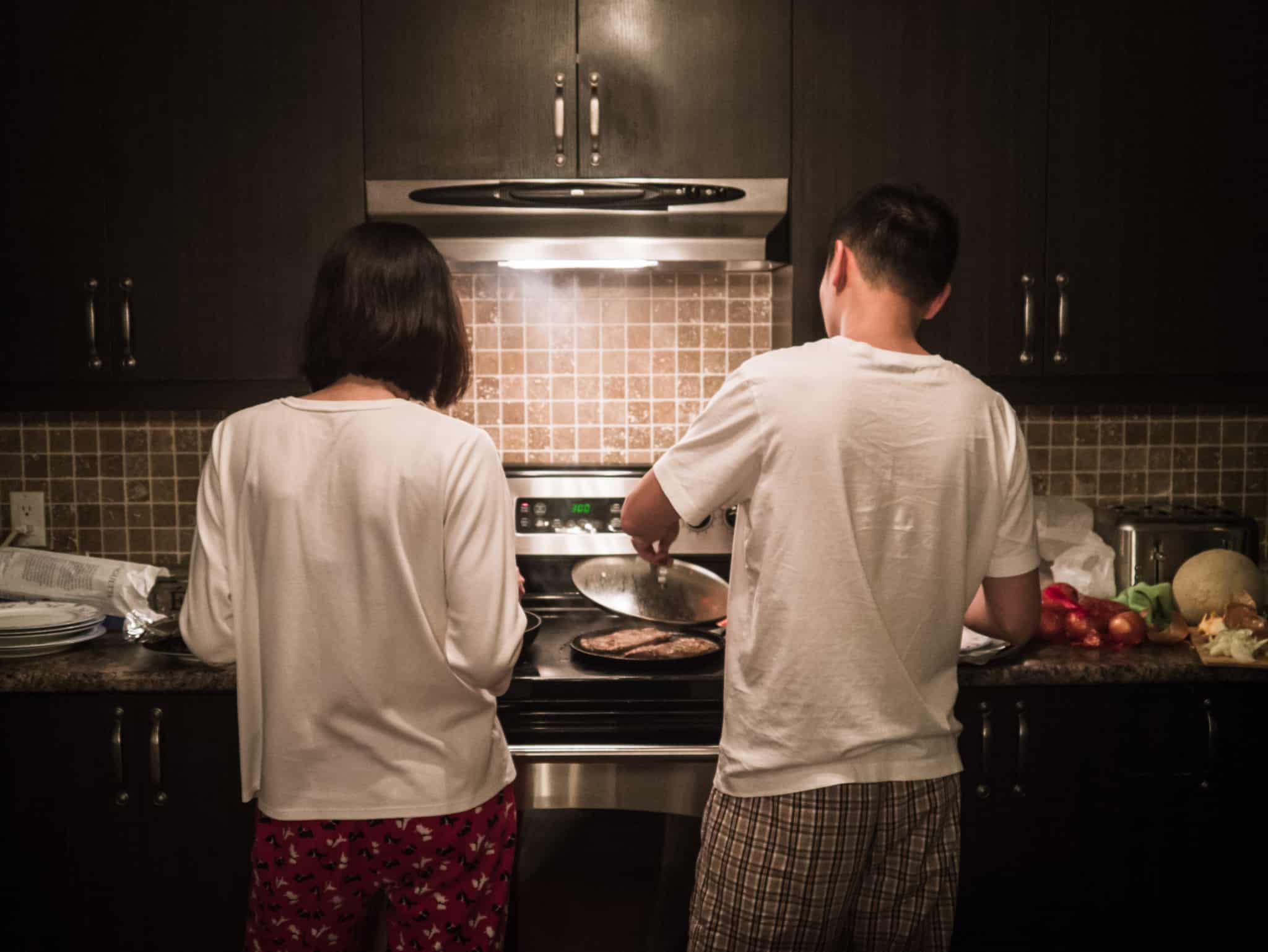 young couple cooking, enjoying equipment with light and gas that are now suffering increases