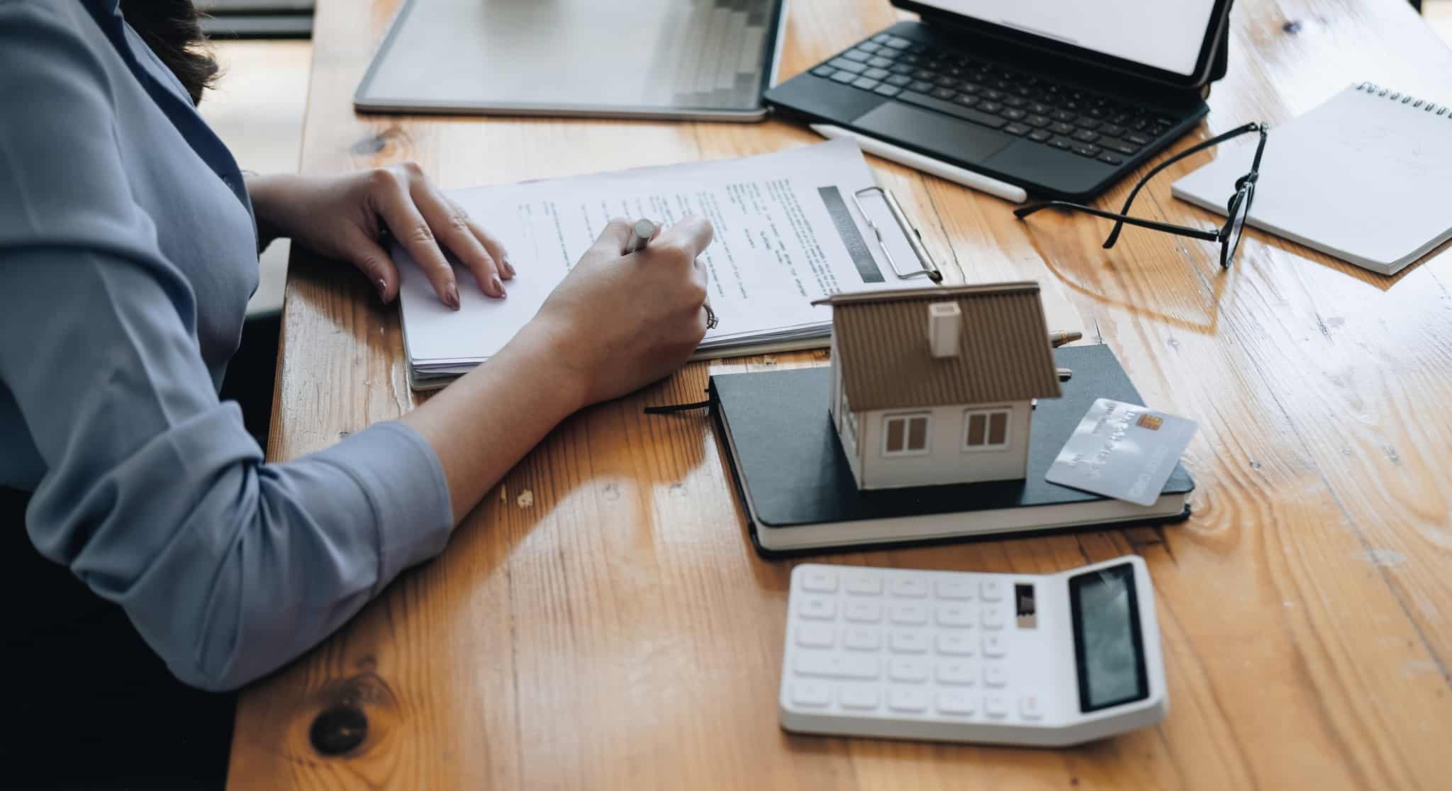 real estate agent signing a document for home loan approval