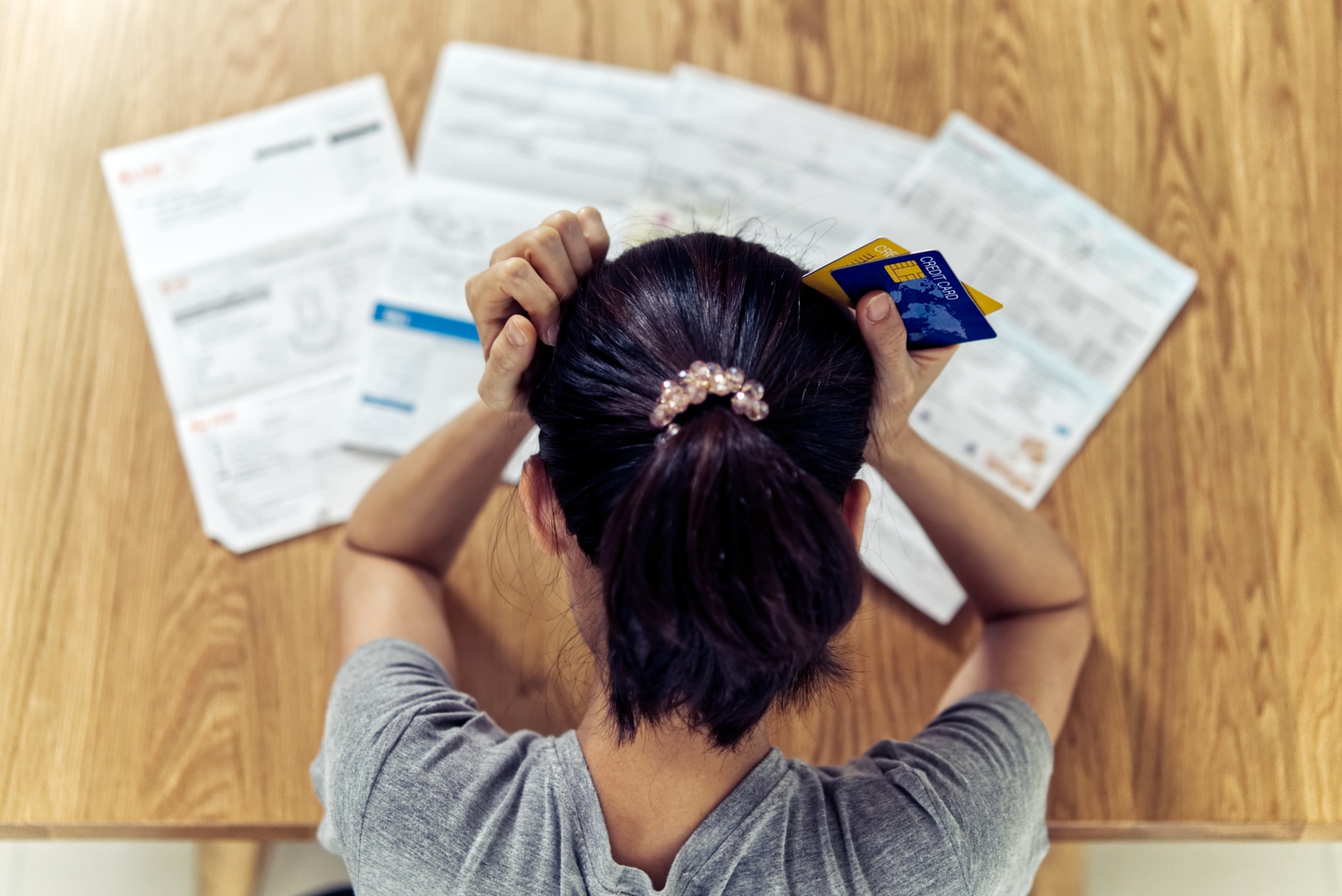 desperate woman looking at credit cards statement